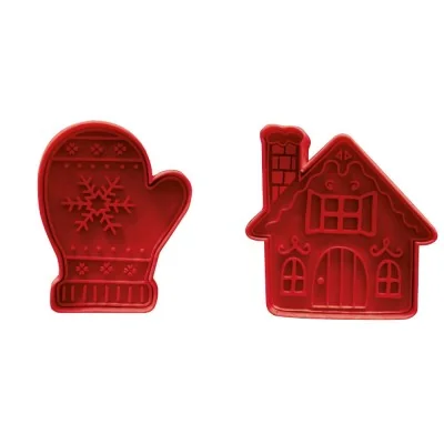 Deux emporte-pièces éjecteurs rouges en forme de maison et de moufle de Noël